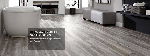 Modern living room featuring waterproof wood-look SPC flooring installed over tiles. 