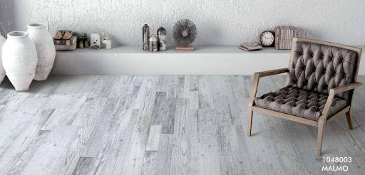 SPC flooring installed over existing ceramic tiles in a modern living room. 